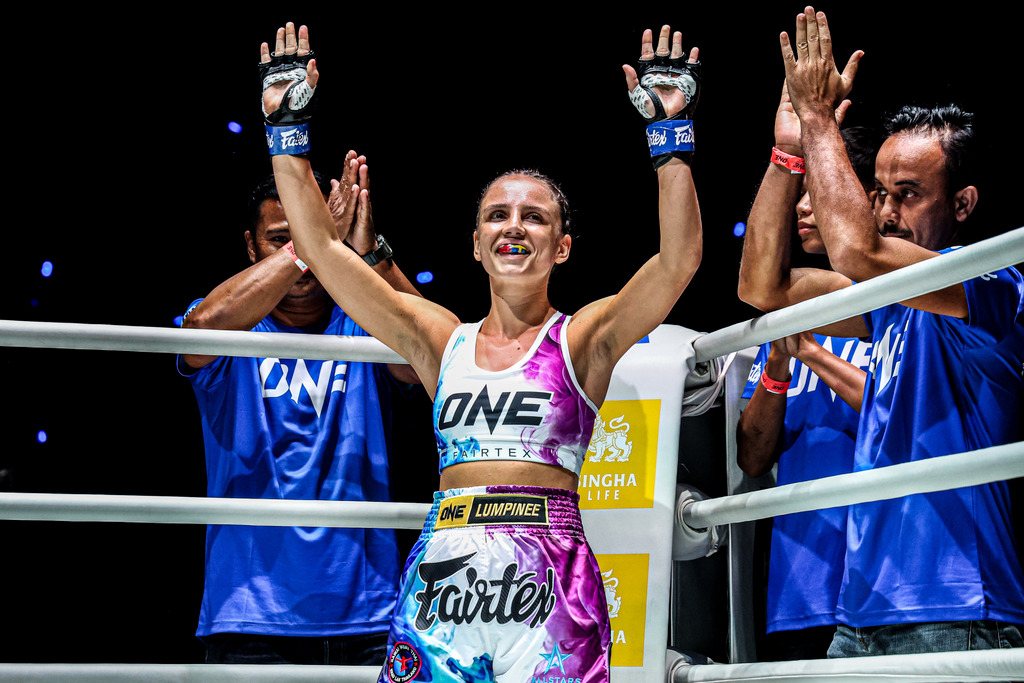 Vanessa Romanowski celebrating with her team in the ring